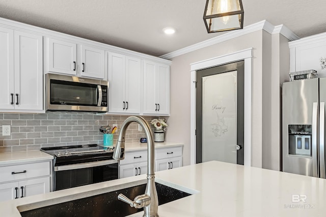 22310 Early Dawn Cir, Foley, AL 36535 - kitchen with crown molding, appliances with stainless steel finishes, tasteful backsplash, light countertops, and white cabinets