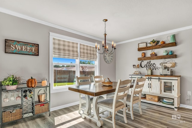 22310 Early Dawn Cir, Foley, AL 36535 - dining area featuring crown molding, baseboards, wood finished floors, and a chandelier