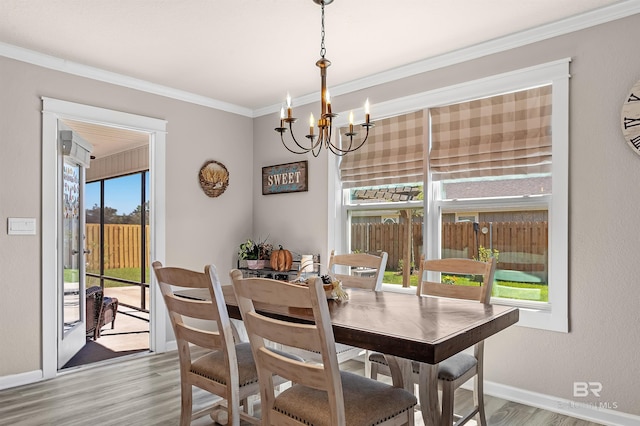 22310 Early Dawn Cir, Foley, AL 36535 - dining area featuring an inviting chandelier, baseboards, crown molding, and wood finished floors