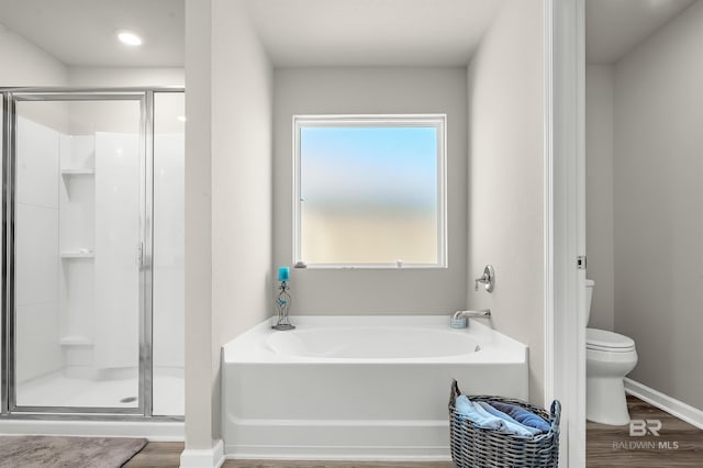 22310 Early Dawn Cir, Foley, AL 36535 - bathroom with wood finished floors, a bath, and a stall shower