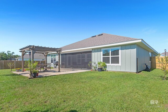 22310 Early Dawn Cir, Foley, AL 36535 - back of property with a pergola, a shingled roof, board and batten siding, a fenced backyard, and a patio area