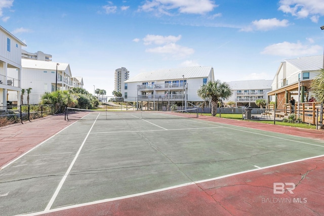 view of tennis court featuring fence