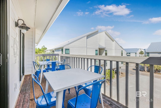 balcony featuring a residential view and outdoor dining area