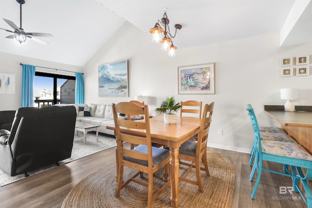 dining room featuring ceiling fan, vaulted ceiling, baseboards, and wood finished floors