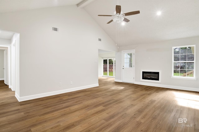 unfurnished living room with a ceiling fan, high vaulted ceiling, baseboards, beamed ceiling, and wood finished floors