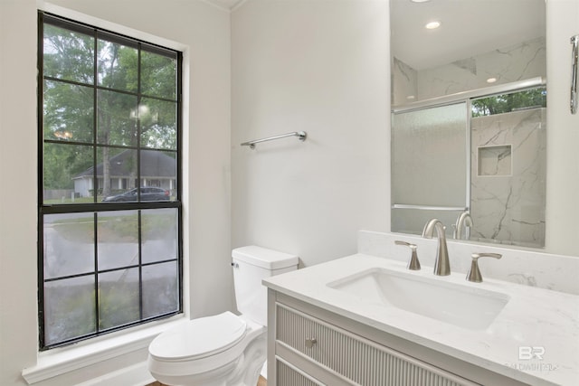 full bath featuring toilet, vanity, a marble finish shower, and recessed lighting