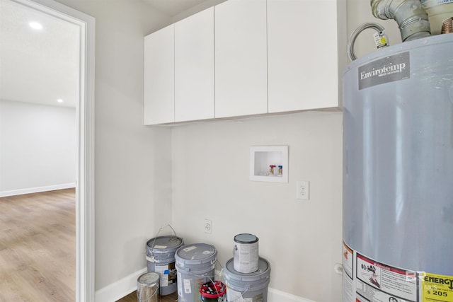 washroom featuring gas water heater, washer hookup, baseboards, wood finished floors, and recessed lighting