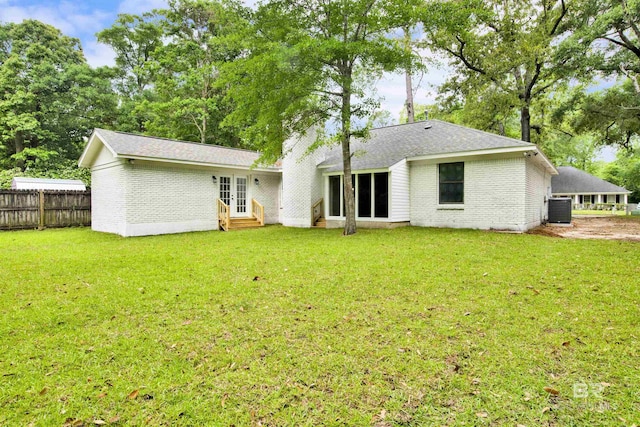 back of house with entry steps, brick siding, central AC, french doors, and roof with shingles