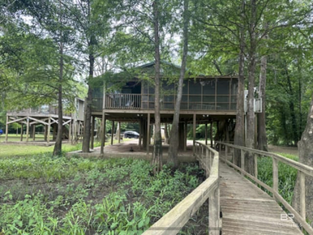 back of house featuring a wooden deck and a sunroom