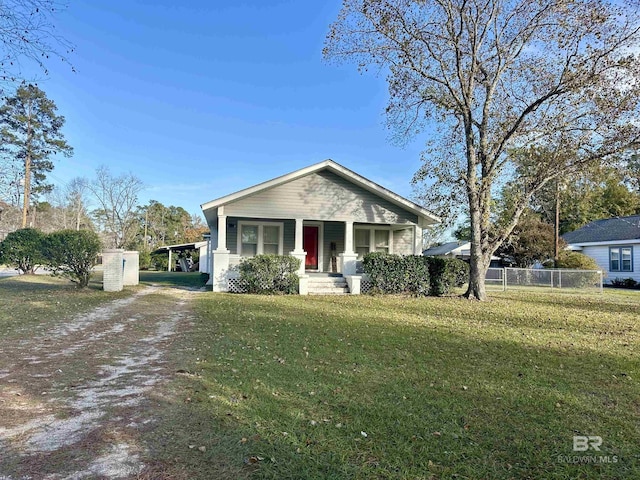 view of front of home with covered porch and a front lawn