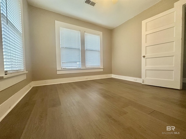 unfurnished room featuring dark hardwood / wood-style floors