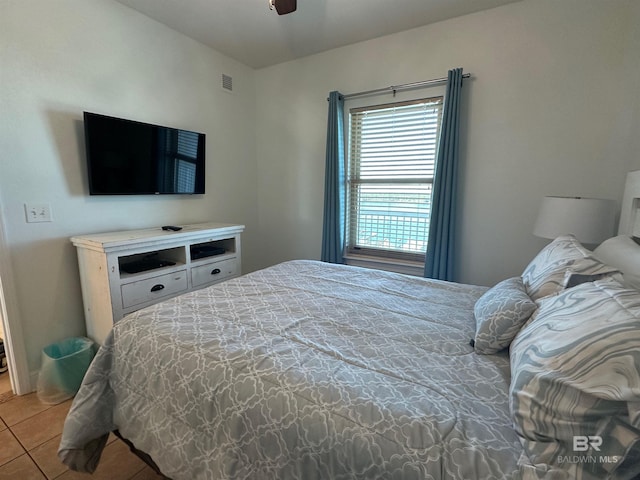 tiled bedroom with visible vents and a ceiling fan