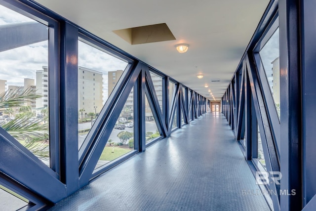 corridor with expansive windows and a view of city