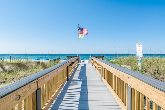 surrounding community featuring a water view and a view of the beach