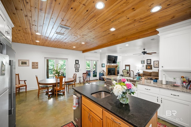 kitchen with white cabinetry, wooden ceiling, and sink