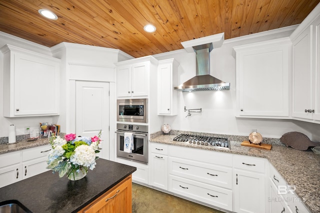 kitchen featuring stainless steel appliances, light stone counters, white cabinets, wall chimney range hood, and wooden ceiling