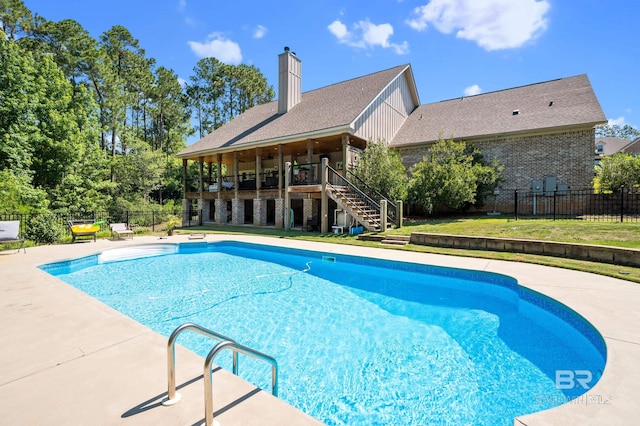 view of pool featuring a patio area and a yard