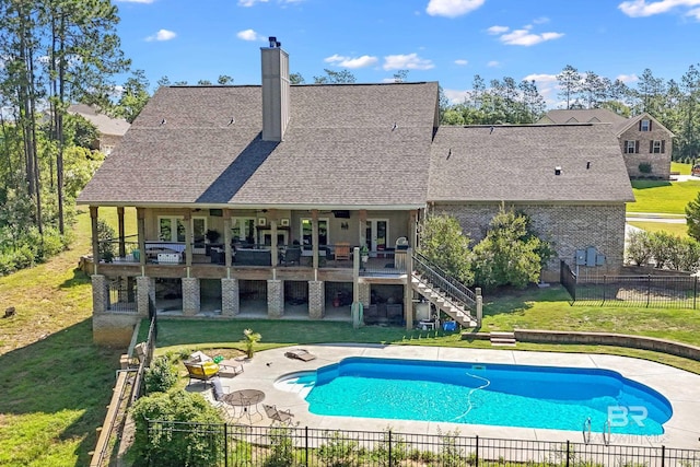 view of pool featuring a patio area, a lawn, and a deck