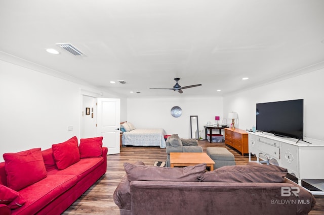 living room with hardwood / wood-style floors, ceiling fan, and crown molding