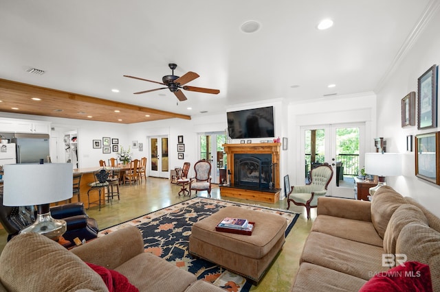 living room with ceiling fan, french doors, beamed ceiling, and crown molding