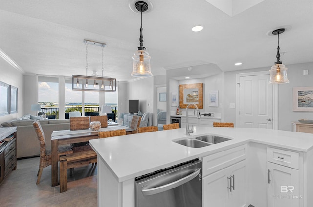 kitchen with pendant lighting, dishwasher, sink, white cabinetry, and a center island with sink