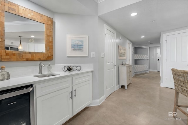 interior space with wine cooler and sink