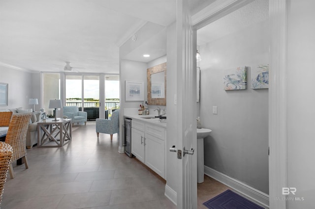 bathroom featuring wine cooler, ceiling fan, crown molding, and sink