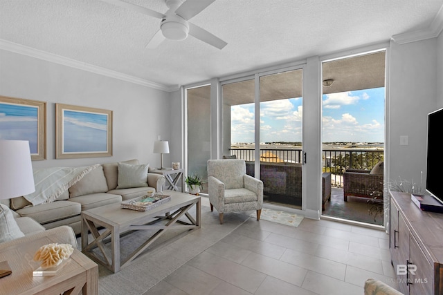 living room featuring floor to ceiling windows, ceiling fan, and a textured ceiling