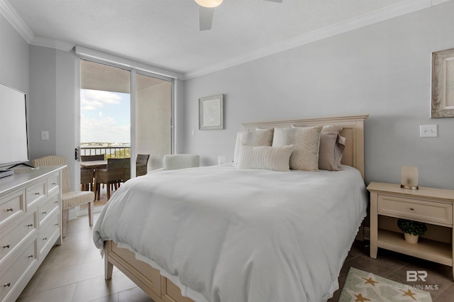 tiled bedroom with a textured ceiling, ornamental molding, and ceiling fan