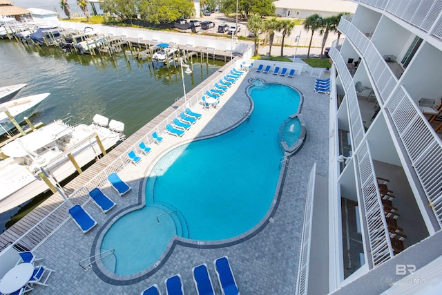 view of pool featuring a water view and a patio area