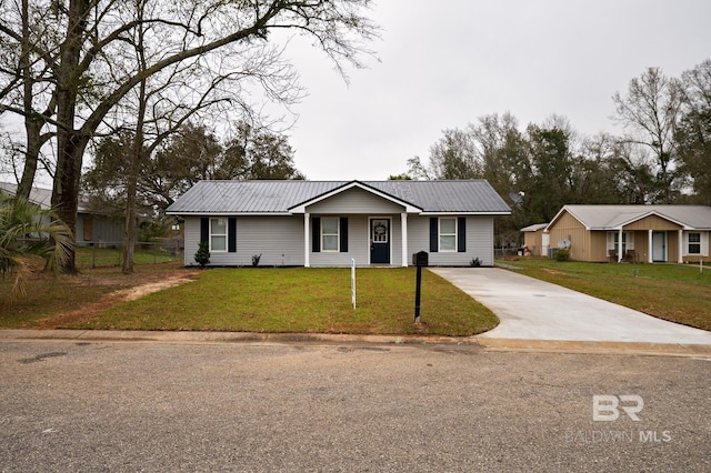 ranch-style house featuring driveway, metal roof, a front yard, and fence