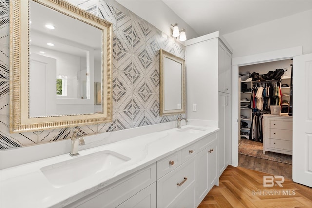 bathroom with parquet flooring and vanity