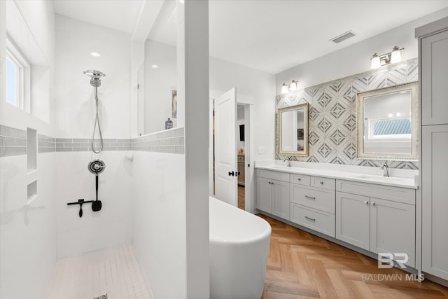 bathroom with vanity, walk in shower, parquet floors, and plenty of natural light