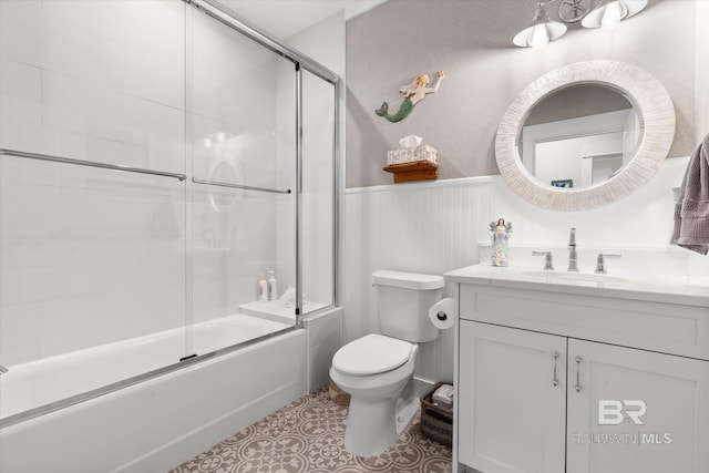 full bathroom with toilet, combined bath / shower with glass door, and vanity