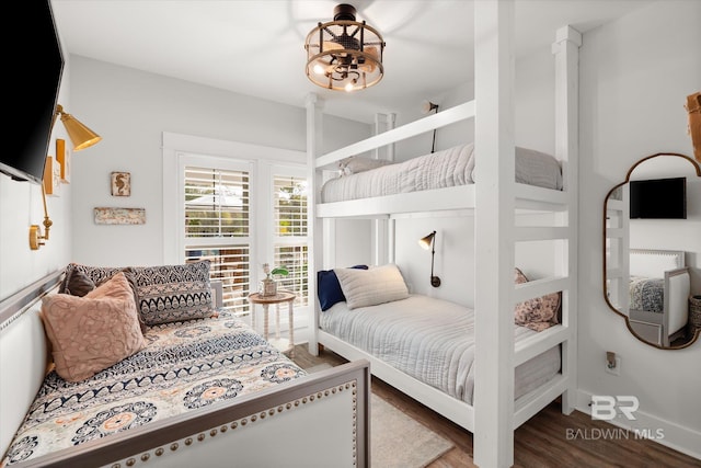 bedroom with dark hardwood / wood-style flooring