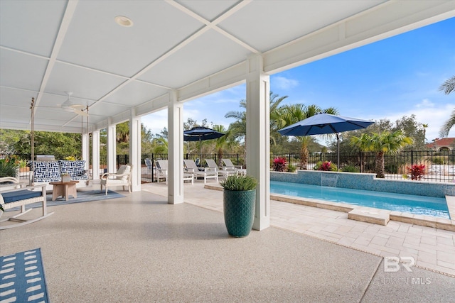 view of swimming pool featuring ceiling fan, a patio area, and pool water feature