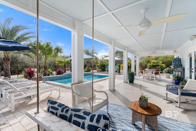 view of swimming pool with ceiling fan and a patio