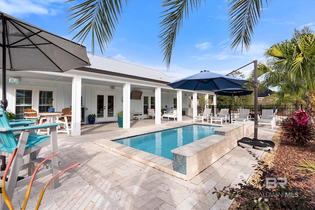 view of swimming pool featuring french doors and a patio area