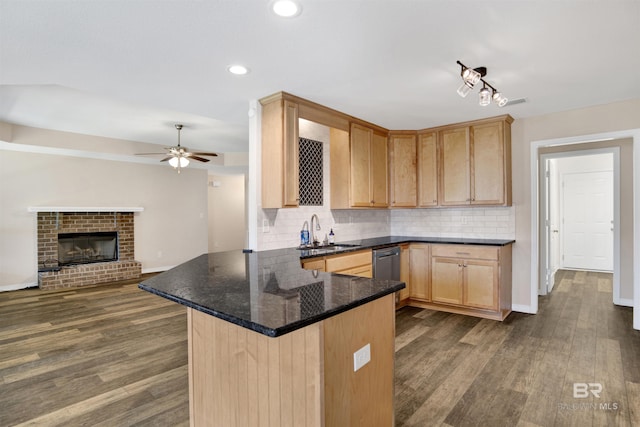 kitchen with a sink, backsplash, dark wood-style flooring, and light brown cabinets