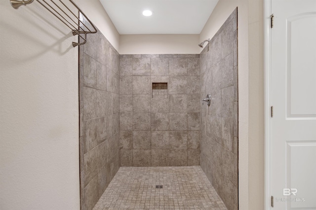 full bath featuring a tile shower