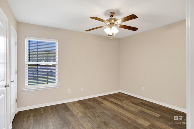 empty room featuring dark wood-type flooring, baseboards, and ceiling fan