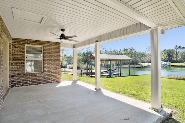 view of patio / terrace featuring a water view and a ceiling fan