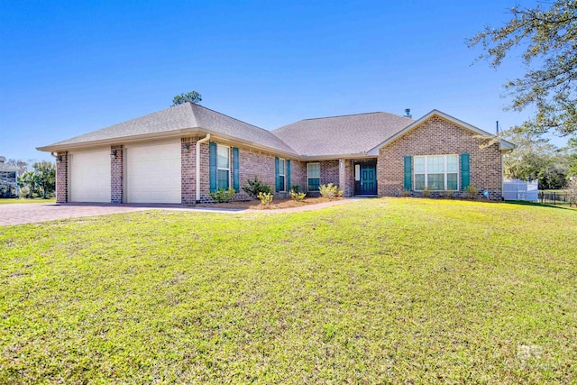 single story home with brick siding, fence, a front yard, a garage, and driveway