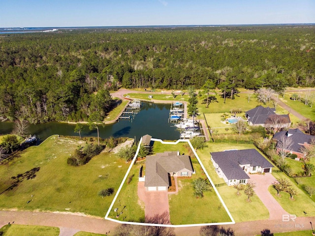 bird's eye view with a forest view and a water view