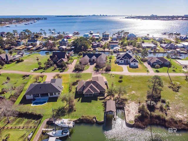 drone / aerial view with a residential view and a water view