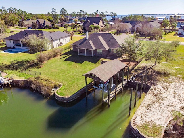 drone / aerial view with a residential view and a water view