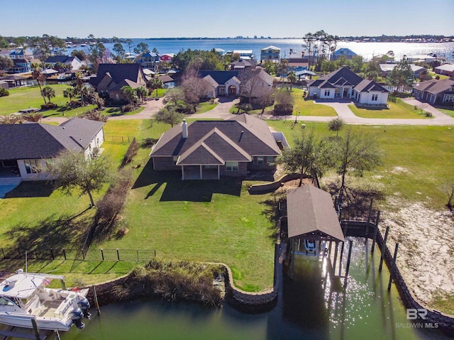 drone / aerial view featuring a residential view and a water view