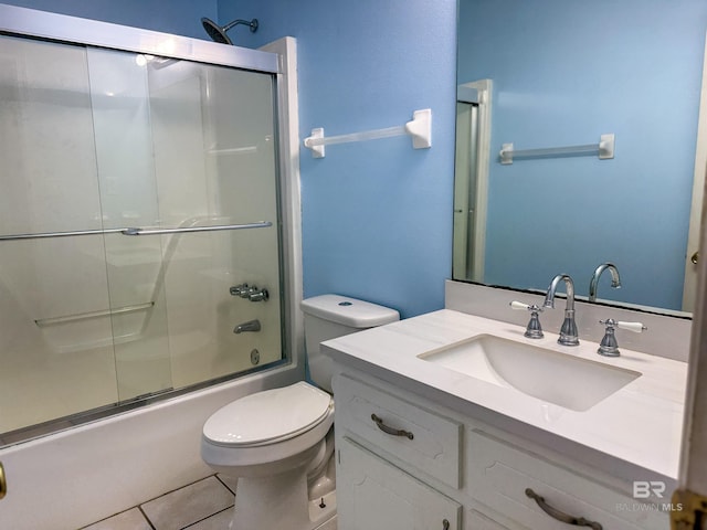 full bathroom featuring toilet, tile patterned floors, vanity, and shower / bath combination with glass door