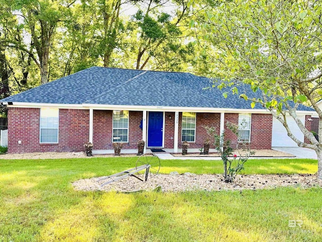 ranch-style home with a front yard, brick siding, and a shingled roof