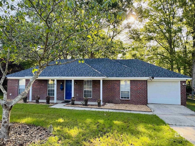 ranch-style home featuring an attached garage, concrete driveway, brick siding, a front lawn, and roof with shingles